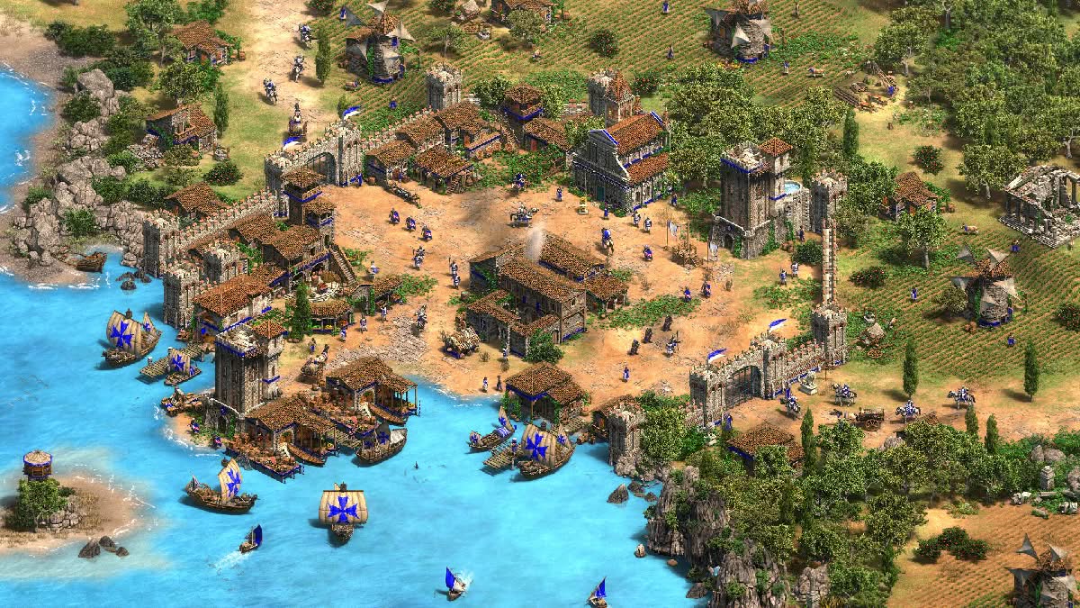Age of Empires 2 Definitive Edition, peaceful coastal base with fortification walls, ships, fields and units everywhere giving it life