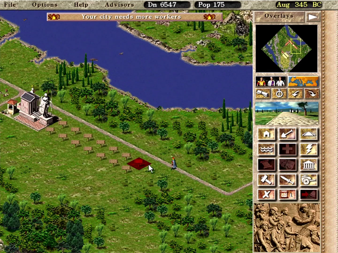 Début d'une cité dans Caesar III, emplacements de maisons à construire le long d'une route impériale
