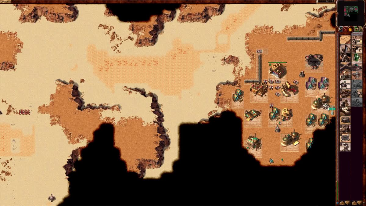 Colonne de tanks entrant dans une base ennemie dans Dune 2000