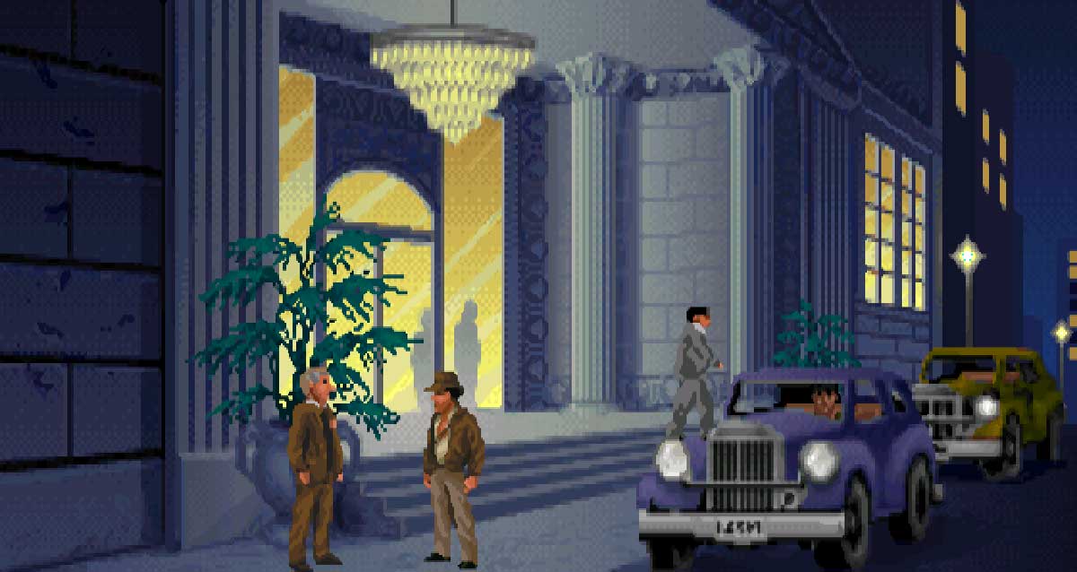 Indiana Jones parle à un personnage dans la rue de nuit avec deux voitures - Fate of Atlantis